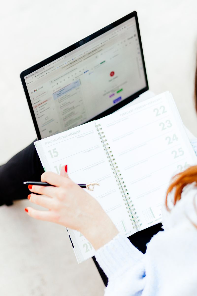 Calendar planning beside a laptop