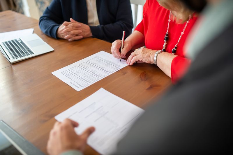 Business documents being signed at a meeting