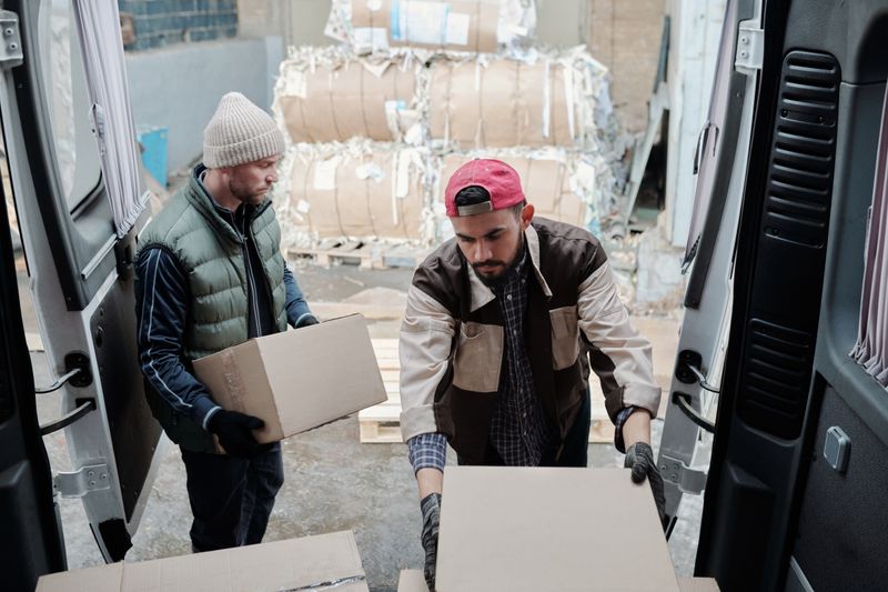 Delivery workers moving packages from a van